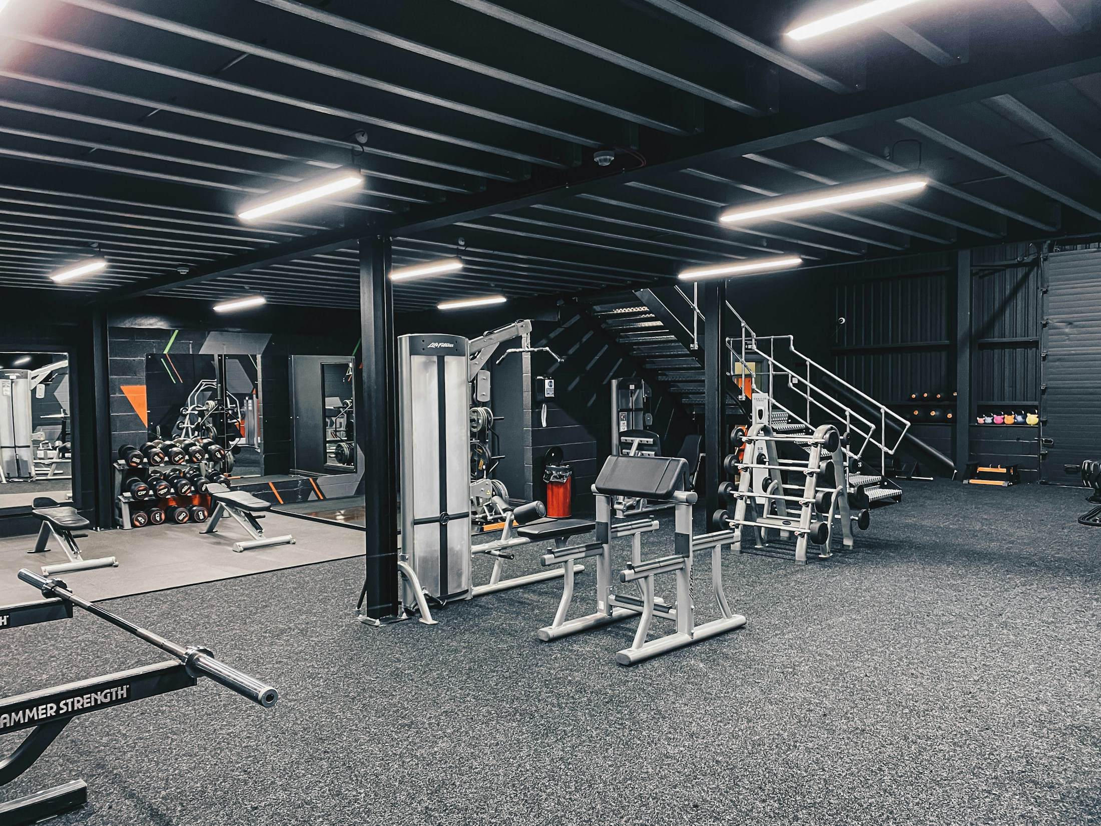 Commercial gym with an open training floor and strength equipment